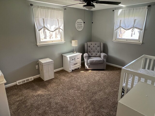 6201 E Holly Rd, Holly, MI 48442 - bedroom featuring dark carpet, baseboards, a nursery area, and visible vents