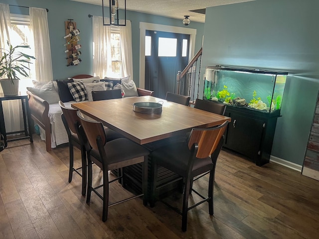 6201 E Holly Rd, Holly, MI 48442 - dining area with plenty of natural light, dark wood-type flooring, baseboards, and a textured ceiling