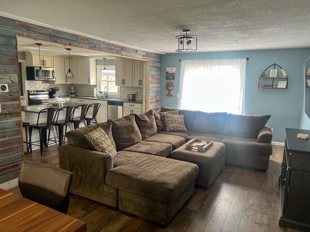 6201 E Holly Rd, Holly, MI 48442 - living room featuring dark wood-style floors and a textured ceiling