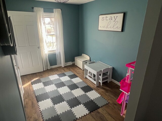 6201 E Holly Rd, Holly, MI 48442 - bedroom featuring baseboards and wood finished floors
