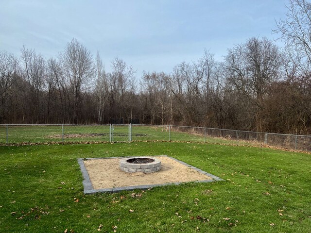6201 E Holly Rd, Holly, MI 48442 - view of yard featuring a fire pit and fence