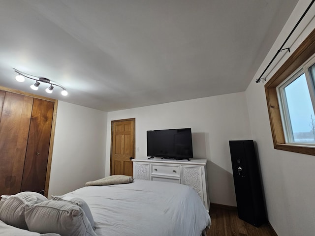 bedroom with baseboards and dark wood finished floors