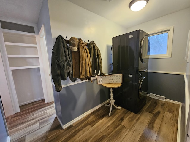 interior space featuring visible vents, baseboards, and wood finished floors