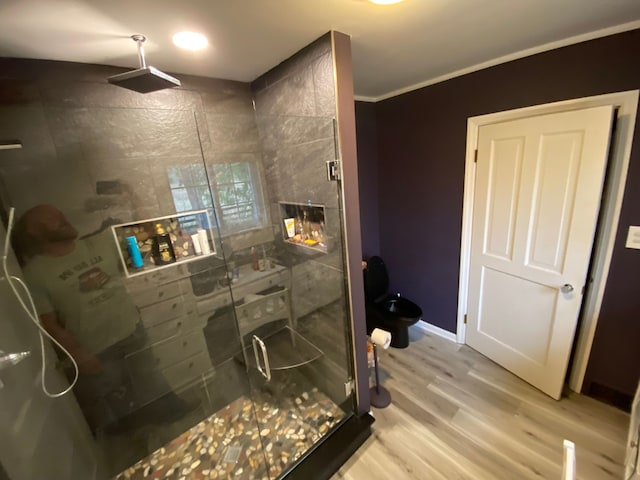 8162 Groveland Rd, Holly, MI 48442 - bathroom with a stall shower, wood finished floors, ornamental molding, toilet, and baseboards