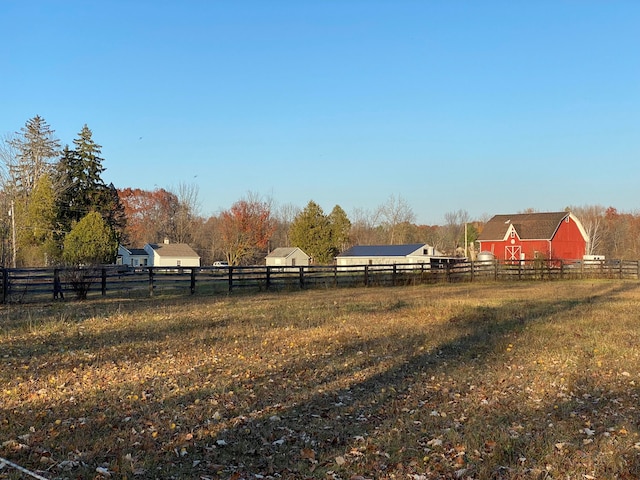 8162 Groveland Rd, Holly, MI 48442 - view of yard with fence, a view of countryside, an outdoor structure, and a barn