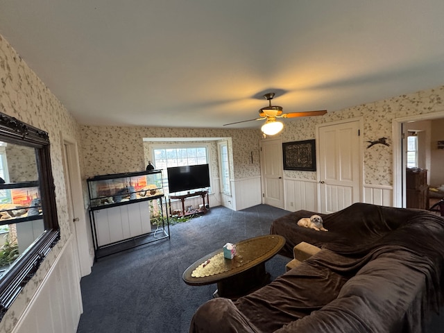 8162 Groveland Rd, Holly, MI 48442 - living room with wallpapered walls, a wainscoted wall, dark colored carpet, and a ceiling fan