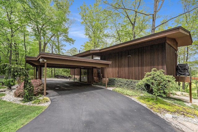 403 Riverview Dr, Ann Arbor, MI 48104 - view of parking / parking lot with asphalt driveway and a carport