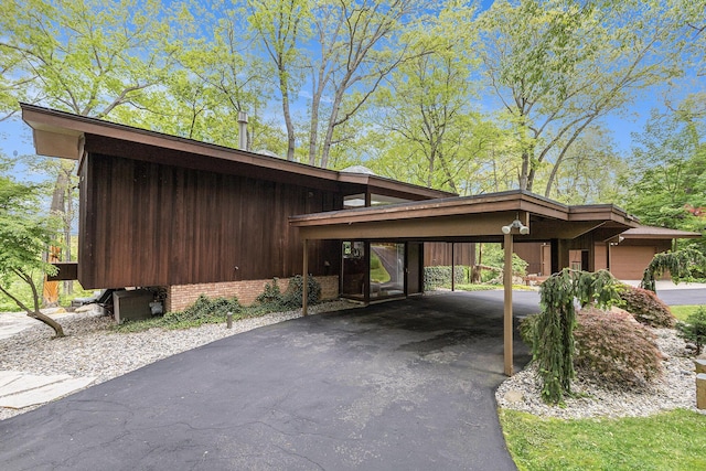 403 Riverview Dr, Ann Arbor, MI 48104 - view of parking featuring driveway and an attached carport