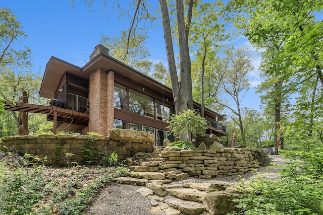 403 Riverview Dr, Ann Arbor, MI 48104 - view of property exterior with a sunroom and a chimney