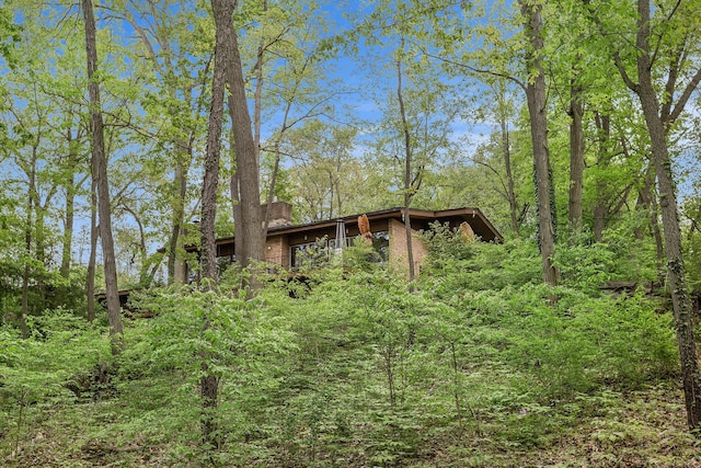 403 Riverview Dr, Ann Arbor, MI 48104 - view of front of house featuring a chimney and a view of trees