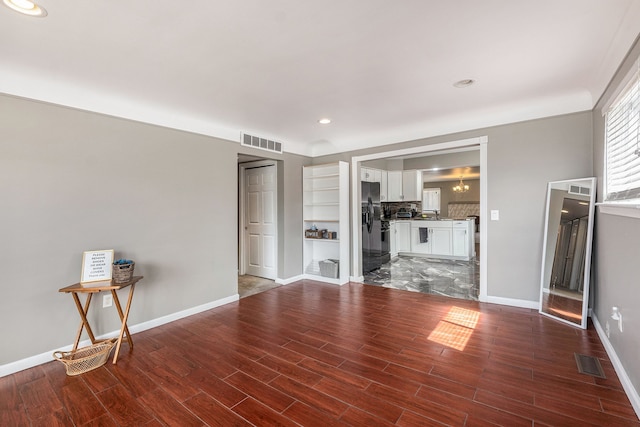 unfurnished living room with baseboards, visible vents, recessed lighting, and wood finished floors