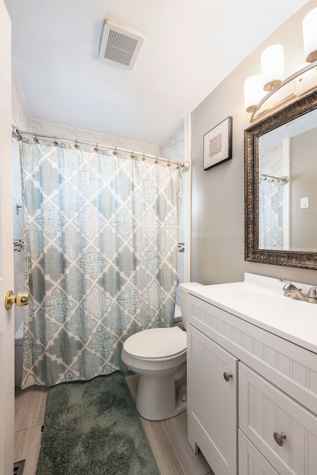 full bath featuring a shower with curtain, visible vents, toilet, and vanity