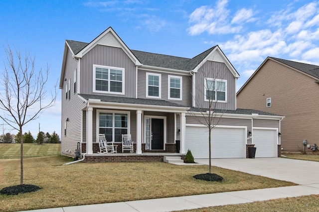 view of front of home featuring an attached garage, board and batten siding, a porch, a front yard, and driveway
