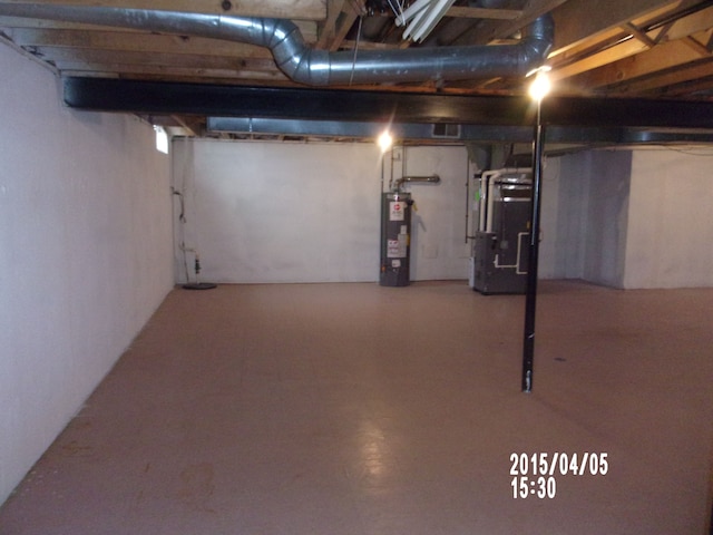 unfinished basement featuring water heater and heating unit