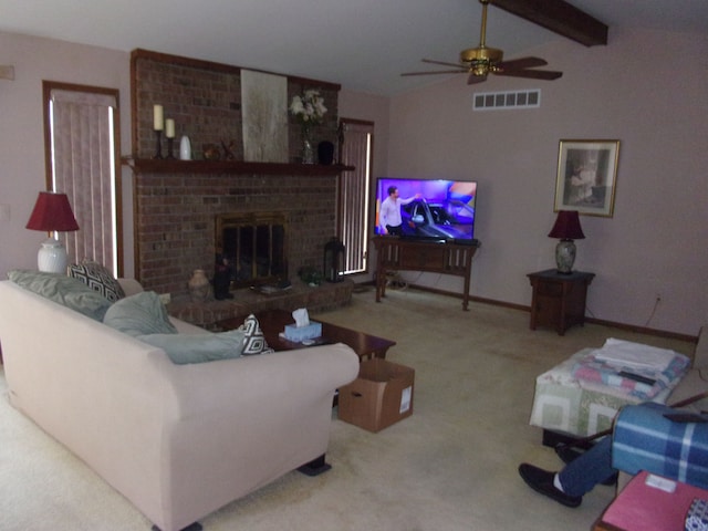 carpeted living room with visible vents, baseboards, a fireplace, a ceiling fan, and vaulted ceiling with beams