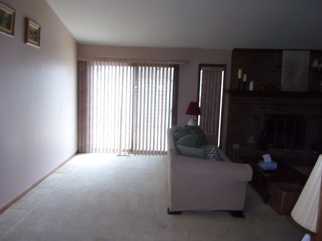 carpeted living area with baseboards and a fireplace