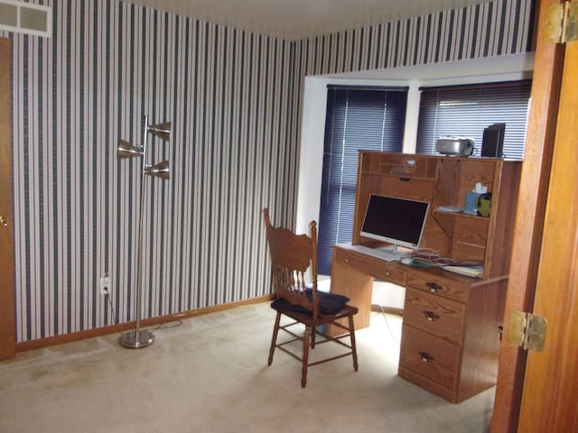 carpeted office space with baseboards and wallpapered walls