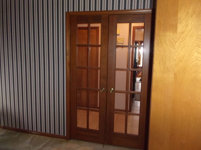 interior details with carpet flooring, wallpapered walls, and french doors