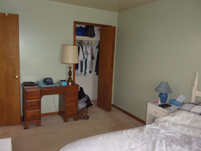 bedroom featuring baseboards and a closet