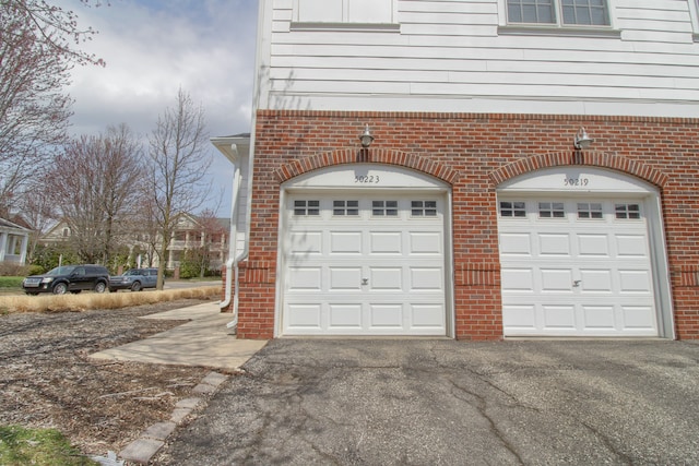 garage with aphalt driveway