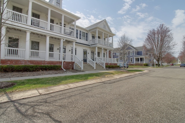 view of front of property featuring covered porch and a balcony