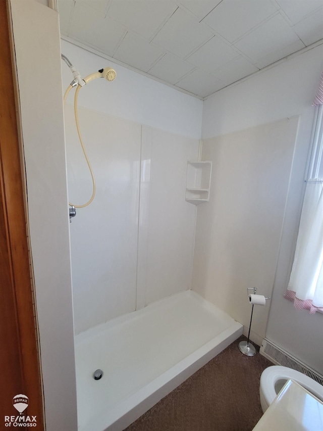 bathroom featuring toilet and walk in shower