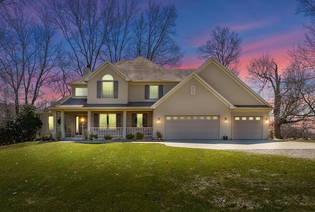 view of front of property with a chimney, a garage, a lawn, driveway, and covered porch