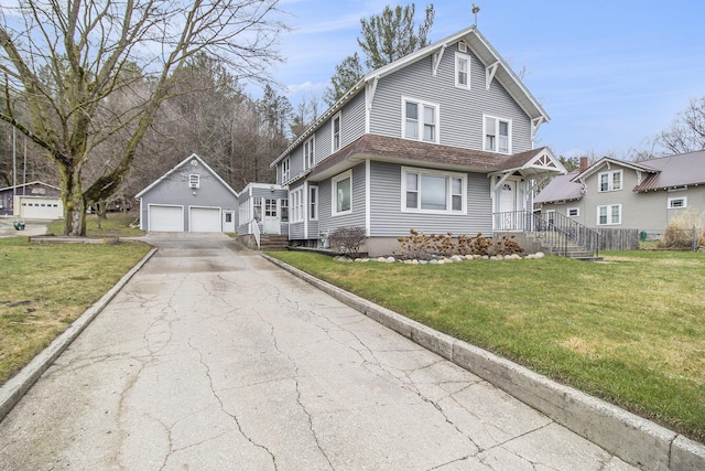 4877 1st St, New Era, MI 49446 - view of front of home with a detached garage, an outbuilding, a front lawn, and a shingled roof