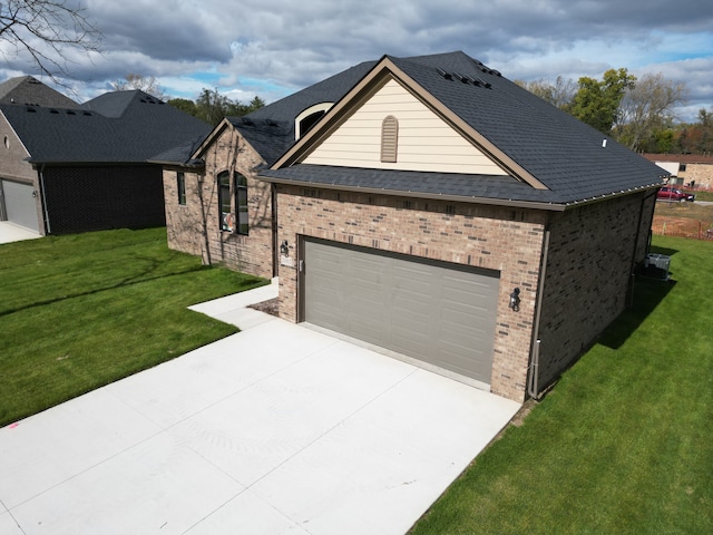 21812 Duns Scotus St # 7, Southfield, MI 48075 - view of front of home featuring brick siding, a front lawn, driveway, and an attached garage