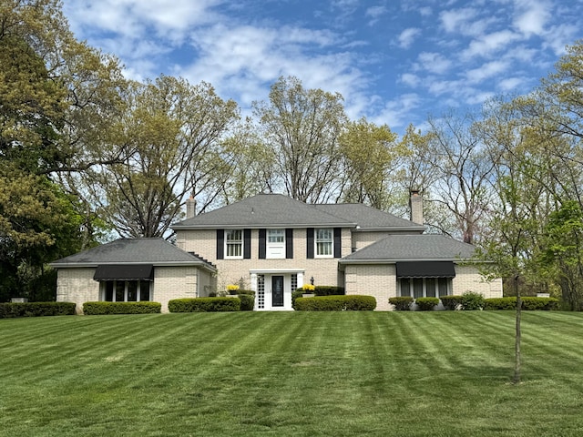 1625 Arlington Blvd, Ann Arbor, MI 48104 - view of front of property featuring brick siding, a front lawn, and a chimney