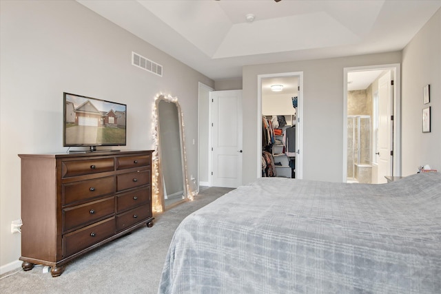 30909 Asbury Hill Ct, New Hudson, MI 48165 - carpeted bedroom featuring a spacious closet, baseboards, a raised ceiling, connected bathroom, and visible vents