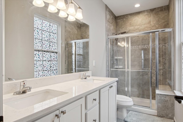 30909 Asbury Hill Ct, New Hudson, MI 48165 - bathroom with toilet, a sink, a stall shower, and double vanity