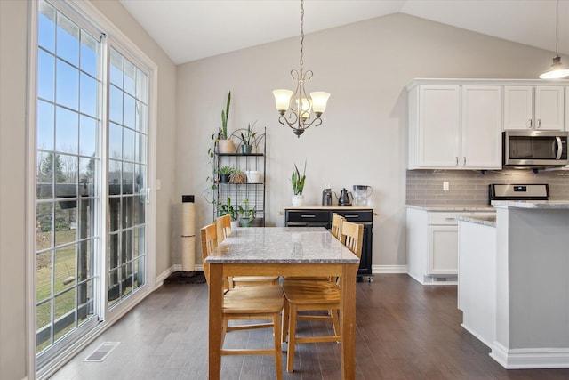 30909 Asbury Hill Ct, New Hudson, MI 48165 - kitchen featuring decorative backsplash, stainless steel appliances, white cabinetry, dark wood-style floors, and a notable chandelier