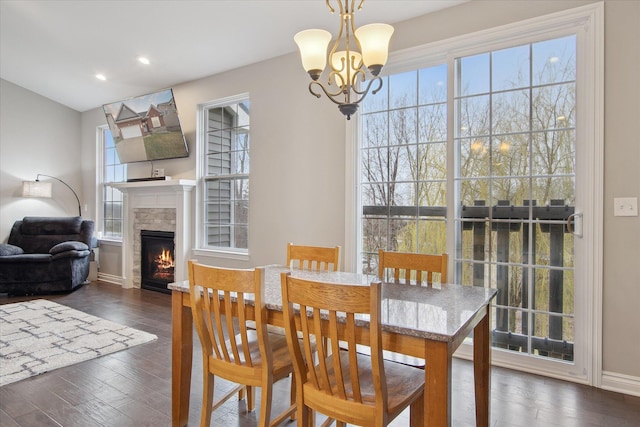 30909 Asbury Hill Ct, New Hudson, MI 48165 - dining room featuring a chandelier, baseboards, recessed lighting, dark wood finished floors, and a glass covered fireplace