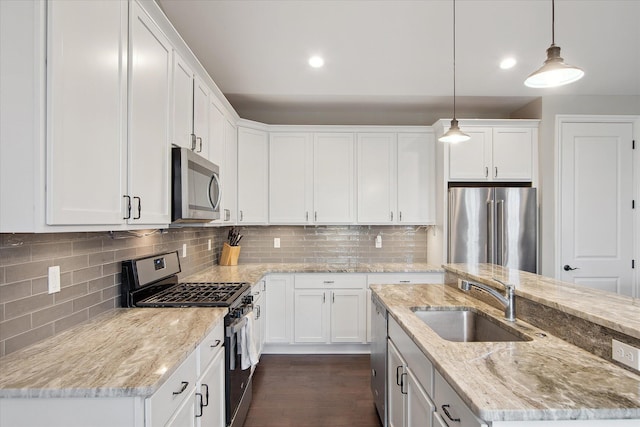 30909 Asbury Hill Ct, New Hudson, MI 48165 - kitchen with a kitchen island with sink, white cabinets, a sink, and stainless steel appliances
