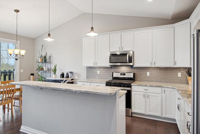 30909 Asbury Hill Ct, New Hudson, MI 48165 - kitchen with vaulted ceiling, dark wood-style flooring, a center island, white cabinets, and appliances with stainless steel finishes