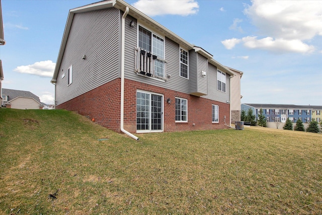 30909 Asbury Hill Ct, New Hudson, MI 48165 - rear view of house featuring brick siding, central AC unit, and a lawn