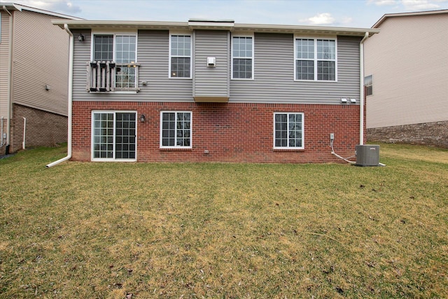30909 Asbury Hill Ct, New Hudson, MI 48165 - back of house featuring central air condition unit, brick siding, and a yard