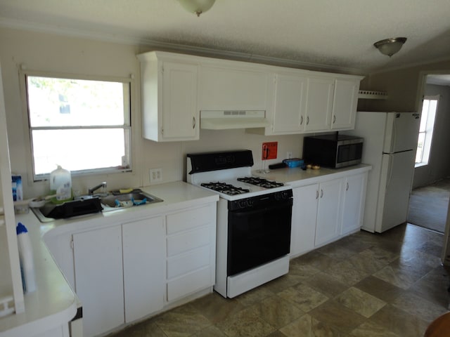 22025 Duvall, Romulus, MI 48174 - kitchen featuring range with gas stovetop, freestanding refrigerator, stainless steel microwave, under cabinet range hood, and white cabinets