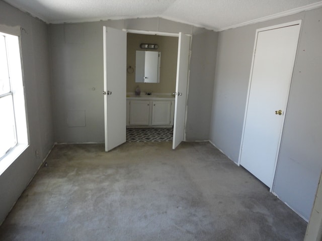 22025 Duvall, Romulus, MI 48174 - unfurnished bedroom featuring ensuite bath, vaulted ceiling, and light carpet