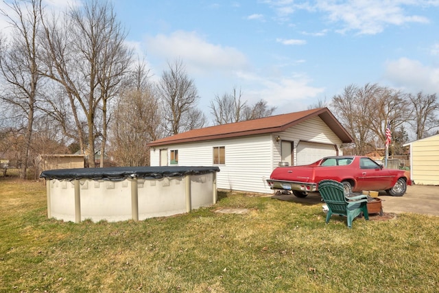 2981 Harrison St, Saginaw, MI 48604 - exterior space with a lawn, an outdoor structure, a garage, and a covered pool