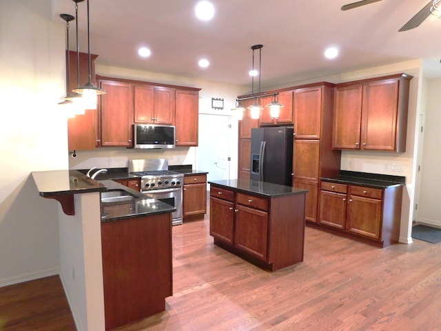 2535 Holiday House Rd Unit 24, Saint Joseph, MI 49085 - kitchen with stainless steel appliances, a sink, ceiling fan, a peninsula, and dark wood-style flooring