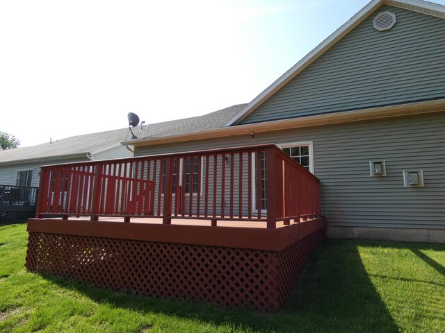 2535 Holiday House Rd Unit 24, Saint Joseph, MI 49085 - rear view of house with a lawn and a wooden deck