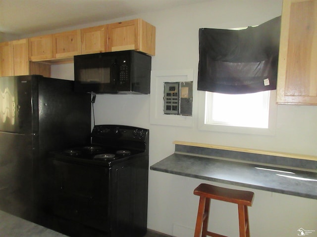4393 2nd St, Newport, MI 48166 - kitchen with electric panel, light brown cabinets, black appliances, and dark countertops