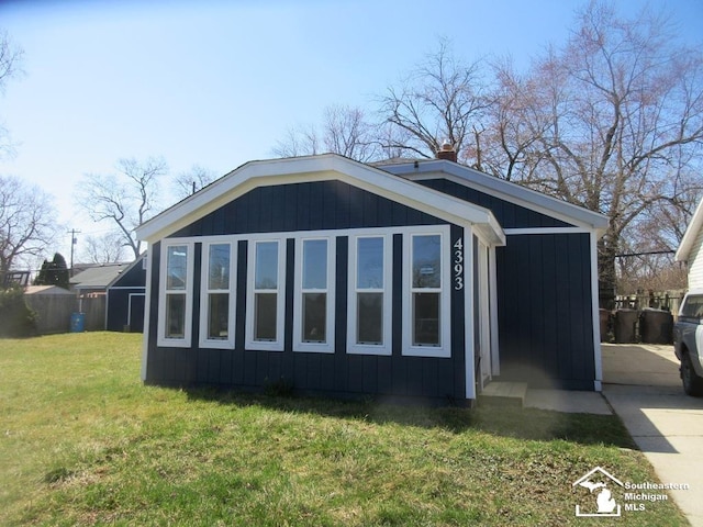 4393 2nd St, Newport, MI 48166 - view of property exterior featuring a chimney and a lawn