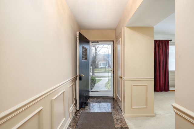 341 Ridgemont Rd, Grosse Pointe Farms, MI 48236 - doorway with plenty of natural light, a decorative wall, wainscoting, and marble finish floor