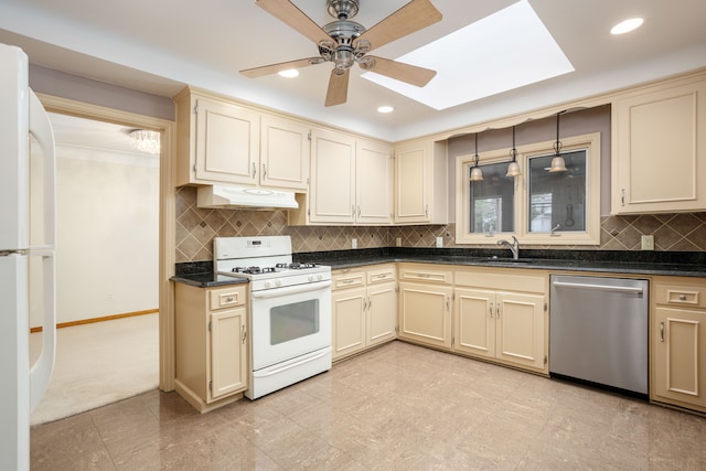 341 Ridgemont Rd, Grosse Pointe Farms, MI 48236 - kitchen with white appliances, under cabinet range hood, dark countertops, and cream cabinets