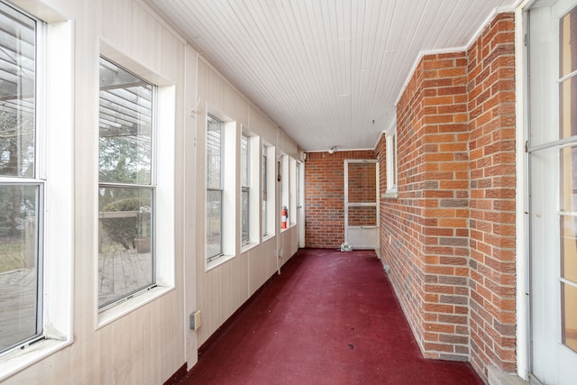 341 Ridgemont Rd, Grosse Pointe Farms, MI 48236 - unfurnished sunroom with brick wall, wood walls, and wooden ceiling