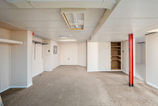 341 Ridgemont Rd, Grosse Pointe Farms, MI 48236 - finished below grade area with a paneled ceiling, carpet flooring, and baseboards
