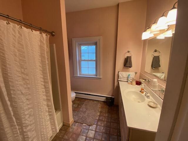 227 Railroad St, Chelsea, MI 48118 - full bath with baseboard heating, vanity, stone finish flooring, shower / bath combo, and toilet